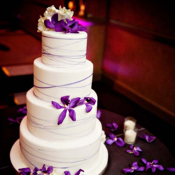 White 4 Tier Cake With Purple Flowers