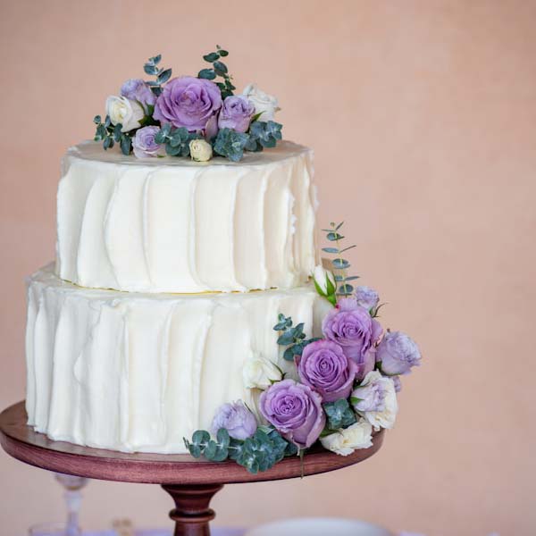 White Wedding Cake With Purple And White Roses